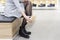 woman trying on new shoes in shoe store. Buy new shoes in boutique of shopping center. view of feet of girl who wears shoes.