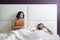 Woman Trying Sexual Approach With Man In Home Bed