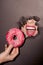 Woman trying to bite donut