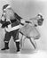 Woman trying to dance with Santa Claus