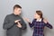 Woman is trying to explain something, man is showing stop gesture