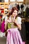 Woman is trying Tracht or dirndl in a shop