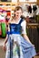 Woman is trying Tracht or dirndl in a shop
