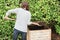 Woman tumbling the compost with a pitch fork