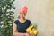 Woman with a turban on her head holds a basket of fruit