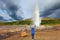 Woman -turist delighted geyser Strokkur