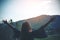 A woman turn back standing and stretching arms with nature and mountain