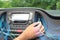 Woman turn on conditioner in car and illustration of cool air flow, closeup