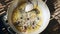 Woman turning over deep frying tarantulas inside a wok using a metal spatula 