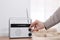 Woman turning volume knob on radio at home, closeup