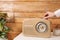 Woman turning volume knob on radio indoors, closeup