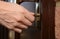 Woman turns the key in a lock on an external door