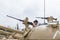 The woman is on the turret of the tank and studies the machine gun on the Memorial Site near the Armored Corps Museum in Latrun, I