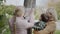 A woman with two children attaches a leaflet about a missing cat to a pole