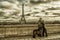 Woman with two dogs admiring the Eiffel Tower in Paris, France