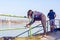 Woman tying jogging shoes. Running outdoors on a sunny day