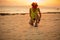 woman tying shoelace before running at sunset sandy beach