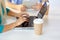 Woman typing on laptop and coffee cups on table