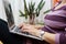 Woman typing on laptop , female using computer sitting