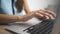 Woman typing on laptop keyboard in the office. Close up woman hands writing on laptop computer keyboard.