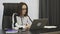 Woman typing on laptop in office. Concentrated lady boss in white blouse working at office. Collected brunette female works at wor