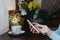 Woman typing text message on smart phone in a cafe on the wooden