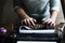 Woman typing vintage typewriter on wooden table