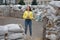 A woman, a Ukrainian patriot, stands on the street of the city at the war in Ukraine, among the barricades of sandbags