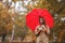 Woman with umbrella in autumn park