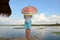 Woman umbrella on a bamboo raft