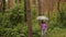 A woman with an umbrella in her hand in the rain. A girl in a purple shirt under an umbrella in the woods. A woman with