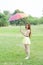 Woman with umbrella standing on the lawn.