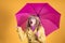 Woman with umbrella and surprise expression