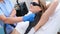 Woman undergoes hair removal procedure with photoepilator or laser hair removal of armpits in salon