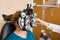 Woman Undergoing Eye Examination With Phoropter