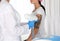 Woman undergoing laser tattoo removal procedure in salon