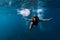 Woman underwater with big jellyfish in ocean. Free diver underwater in transparent sea