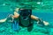 Woman underwater snorkeling with gesturing okay swimming in sea