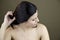 Woman undoing ponytail of long black hair