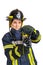 Woman in uniform, hardhat of firefighter opens valve on fire hose nozzle