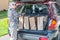 Woman Unloading Grocery Bags from Car