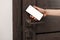 Woman unlocking door using smartphone, closeup view