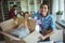 Woman unpacking cartons while family standing in background