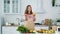 Woman unpacks vegetables and fruits from a supermarket bag