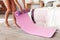 Woman unrolling yoga mat