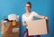 Woman with untidy box in the back holding neat cardboard box