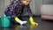 Woman upset with poorly polished floor and stains on wood parquet, cleaning