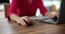 Woman use computer mouse working on computer at table closeup