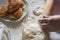 Woman use a rolling pin to press down on the pastry