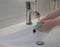 Woman use soap and washing hands under the water tap.